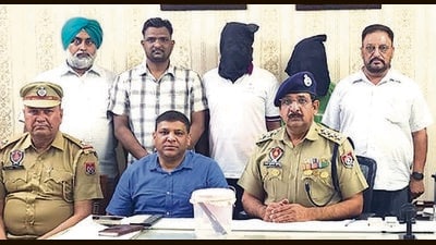 The accused and his aide in the custody of CIA staff 1, Ludhiana, on Monday. (HT Photo)