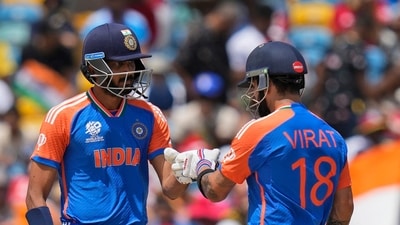 India's Virat Kohli, right, and teammate Axar Patel touch gloves as they bat during the ICC Men's T20 World Cup final cricket match. (PTI) India's Virat Kohli, right, and teammate Axar Patel touch gloves as they bat during the ICC Men's T20 World Cup final cricket match. (PTI)
