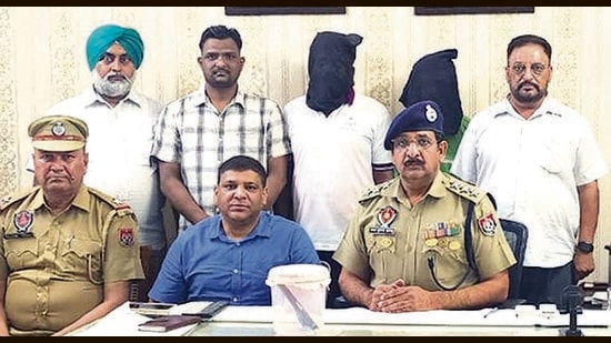 The accused and his aide in the custody of CIA staff 1, Ludhiana, on Monday. (HT Photo)