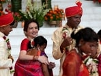 The image shows Nita Ambani hugging a bride at the mass wedding hosted by Ambanis. Mukesh Ambani also attended the celebration. The image shows Nita Ambani hugging a bride at the mass wedding hosted by Ambanis. Mukesh Ambani also attended the celebration.