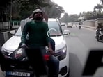 Car hits scooter from behind on a busy Bengaluru road, two people crash on road Car hits scooter from behind on a busy Bengaluru road, two people crash on road