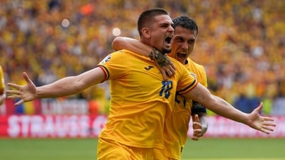 Romania's Razvan Marin, front, celebrates after scoring his side's first goal against Slovakia during a Group E match at the Euro 2024. (AP)
