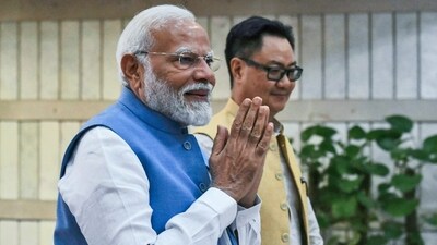 Prime Minister Narendra Modi with union minister Kiren Rijiju. (AP) Prime Minister Narendra Modi with union minister Kiren Rijiju. (AP)