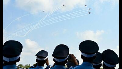 Indian Air Force (IAF) cadets watch the Surya Kiran Aerobatic Team (SKAT) fly in formation during a graduation ceremony at the Air Force Academy in Dundigal, on the outskirts of Hyderabad on June 15, 2024. (Photo by Noah SEELAM / AFP) (AFP)