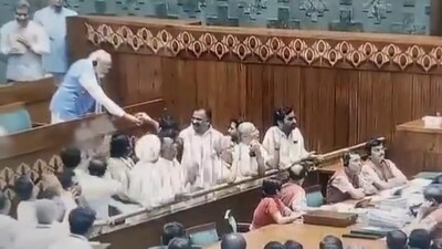 Prime Minister Narendra Modi offers water to opposition MPs who were shouting slogans in the Well of the House.