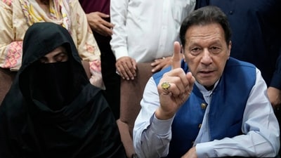 Pakistan's former Prime Minister Imran Khan, right, and Bushra Bibi,his wife. (AP/File)