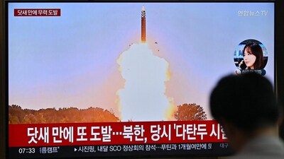 A man watches a television screen showing a news broadcast with file footage of a North Korean missile test, at a train station in Seoul on July 1, 2024. North Korea on July 1, launched two ballistic missiles. (AFP)