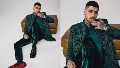 Lastly, Zayn donned a green bandhgala velvet jacket featuring floral threadwork. The singer wore it with a matching silk shirt and velvet pants. A stylish watch, Christian Louboutin shoes, and earrings rounded off the look. (Instagram) Lastly, Zayn donned a green bandhgala velvet jacket featuring floral threadwork. The singer wore it with a matching silk shirt and velvet pants. A stylish watch, Christian Louboutin shoes, and earrings rounded off the look. (Instagram)
