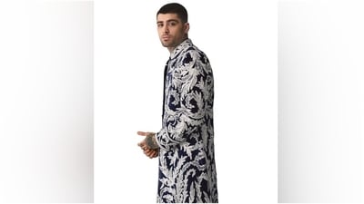 Zayn paired the jacket with a bandhgala blue kurta and matching pants, with his neck tattoos peeking over the collar and cuffs to add a sensual touch. Lastly, he chose a statement silver ring and earrings to accessorise the outfit. (Twitter) Zayn paired the jacket with a bandhgala blue kurta and matching pants, with his neck tattoos peeking over the collar and cuffs to add a sensual touch. Lastly, he chose a statement silver ring and earrings to accessorise the outfit. (Twitter)