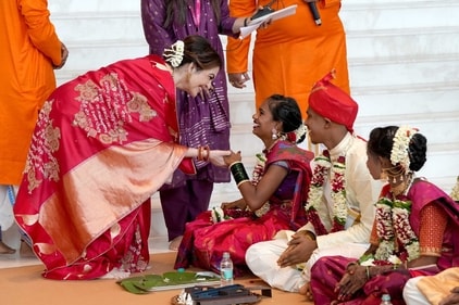 A photo of Nita Ambani with a bride at a mass wedding. (special arrangement) A photo of Nita Ambani with a bride at a mass wedding. (special arrangement)