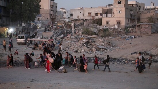 Israeli forces bombed several areas of the southern Gaza Strip on Tuesday and thousands of Palestinians fled their homes (AP)