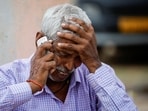 Chedilal, 65, father of Ruby who died in a stampede, speaks on the phone as he mourns outside a hospital in Hathras district of Uttar Pradesh on July 3, 2024.