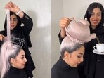 Hairstylist Saeideh Ariaei makes the 'teapot' hairstyle on a model and later pours tea into a cup. Hairstylist Saeideh Ariaei makes the 'teapot' hairstyle on a model and later pours tea into a cup.
