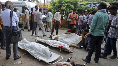 Bodies outside a hospital in Hathras. (AP)