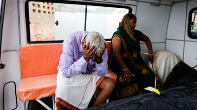 Chedilal and Rajkumari relatives of a stampede victim Ruby, mourn next to her body, outside a hospital in Hathras district of Uttar Pradesh on July 3, 2024. (REUTERS)