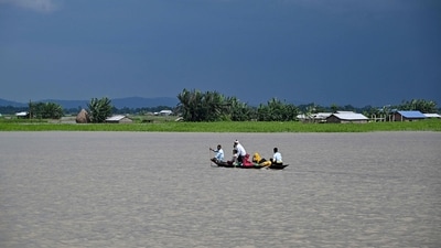 People wade through flood waters on a boat at Lehpati village of Morigaon district in India's northeastern state of Assam on July 3, 2024. (Photo by Biju BORO / AFP) (AFP) People wade through flood waters on a boat at Lehpati village of Morigaon district in India's northeastern state of Assam on July 3, 2024. (Photo by Biju BORO / AFP) (AFP)
