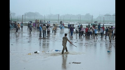 Police officers control a crowd that gathered at the site of Tuesday's stampede as it rains in Hathras district, Uttar Pradesh, India, Wednesday, July 3, 2024. Severe overcrowding and a lack of exits contributed to a stampede at a religious festival in northern India, authorities said Wednesday, leaving more than 100 people dead as the faithful surged toward the preacher to touch him and chaos ensued. (AP Photo/Rajesh Kumar Singh) (AP) Police officers control a crowd that gathered at the site of Tuesday's stampede as it rains in Hathras district, Uttar Pradesh, India, Wednesday, July 3, 2024. Severe overcrowding and a lack of exits contributed to a stampede at a religious festival in northern India, authorities said Wednesday, leaving more than 100 people dead as the faithful surged toward the preacher to touch him and chaos ensued. (AP Photo/Rajesh Kumar Singh) (AP)