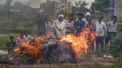 Relatives mourn during the last rites of three members of their family who died in the stampede at Hathras. (PTI) Relatives mourn during the last rites of three members of their family who died in the stampede at Hathras. (PTI)