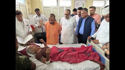 UP CM Yogi Adityanath meeting people injured in the Hathras incident in hospital . (CM’s office X handle)