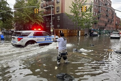 A man working to clean drain in NY. (AP) A man working to clean drain in NY. (AP)