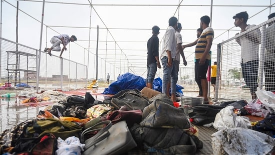 People at the site of the stampede in Hathras on July 03. (Sunil Ghosh / Hindustan Times)