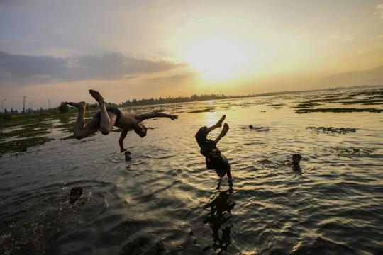 Kashmiri boys jumping into the Dal Lake during a hot summer day in Srinagar. (AP Photo) Kashmiri boys jumping into the Dal Lake during a hot summer day in Srinagar. (AP Photo)