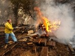 Shane Lawson, an off-duty firefighter, works to extinguish flames from the Grubbs Fire in the Palermo community of Butte County, Calif., on Wednesday, July 3, 2024. Firefighters stopped the fire at around 10 acres. An extended heatwave blanketing Northern California has resulted in red flag fire warnings and power shutoffs. (AP Photo/Noah Berger)