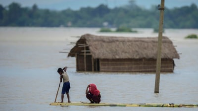 A young boy rows a makeshift banana raft to cross flood waters in Morigaon district in the northeastern Indian state of Assam, India, Wednesday, July 3, 2024. (AP Photo/Anupam Nath) (AP) A young boy rows a makeshift banana raft to cross flood waters in Morigaon district in the northeastern Indian state of Assam, India, Wednesday, July 3, 2024. (AP Photo/Anupam Nath) (AP)