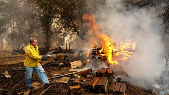 Shane Lawson, an off-duty firefighter, works to extinguish flames from the Grubbs Fire in the Palermo community of Butte County, Calif., on Wednesday, July 3, 2024. Firefighters stopped the fire at around 10 acres. An extended heatwave blanketing Northern California has resulted in red flag fire warnings and power shutoffs. (AP Photo/Noah Berger) (AP)