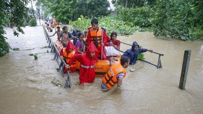NDRF personnel evacuate people from a flood-affected area on the outskirts of Agartala in Tripura on Thursday. (PTI Photo) NDRF personnel evacuate people from a flood-affected area on the outskirts of Agartala in Tripura on Thursday. (PTI Photo)