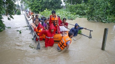 NDRF personnel evacuate people from a flood-affected area on the outskirts of Agartala in Tripura on Thursday. (PTI Photo) (HT_PRINT) NDRF personnel evacuate people from a flood-affected area on the outskirts of Agartala in Tripura on Thursday. (PTI Photo) (HT_PRINT)