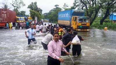 People wade through flood waters in Feni on Thursday. Floods triggered by torrential rains have swamped a swathe of low-lying Bangladesh, disaster officials said. (AFP) People wade through flood waters in Feni on Thursday. Floods triggered by torrential rains have swamped a swathe of low-lying Bangladesh, disaster officials said. (AFP)