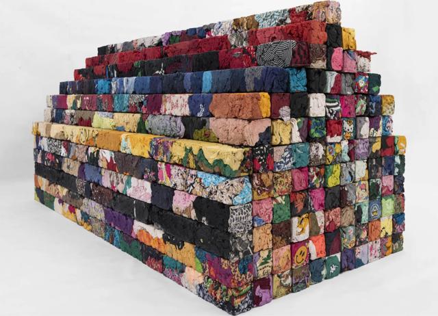 Nai repurposes old cloth pieces to portray the depth and debris of a city. Nai repurposes old cloth pieces to portray the depth and debris of a city.