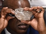 Botswana's President Mokgweetsi Masisi looks at the 2492 carat diamond discovered in the Karowe mine in Gaborone on August 22, 2024 (Monirul Bhuiyan/AFP) Botswana's President Mokgweetsi Masisi looks at the 2492 carat diamond discovered in the Karowe mine in Gaborone on August 22, 2024 (Monirul Bhuiyan/AFP)