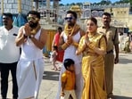 The image shows a family decked in gold jewellery while visiting Tirumala temple. The image shows a family decked in gold jewellery while visiting Tirumala temple.