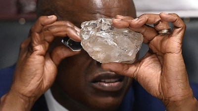 Botswana's President Mokgweetsi Masisi looks at the 2492 carat diamond discovered in the Karowe mine in Gaborone on August 22, 2024 (Monirul Bhuiyan/AFP) Botswana's President Mokgweetsi Masisi looks at the 2492 carat diamond discovered in the Karowe mine in Gaborone on August 22, 2024 (Monirul Bhuiyan/AFP)