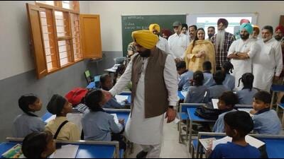 Punjab PWD minister Harbhajan Singh ETO interacts with students at a government school in the state on Friday (HT Photo)