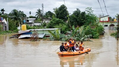 Rescuers from Tripura Disaster Management Authority evacuate flood-affected people to a safer place following heavy rains at a village on the outskirts of Agartala, India, August 22, 2024. (Reuters)