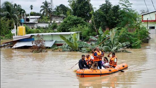 Rescuers from Tripura Disaster Management Authority evacuate flood-affected people to a safer place (Reuters Photo)