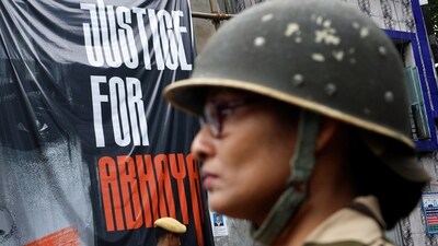 Central Industrial Security Force (CISF) personnel stands guard at the entrance of RG Kar Medical College and Hospital in Kolkata on August 23. (REUTERS)