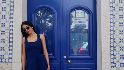Banita Sandhu posed in front of a striking blue door on the streets of Lisbon. She even matched it in her short blue dress. Banita Sandhu posed in front of a striking blue door on the streets of Lisbon. She even matched it in her short blue dress.