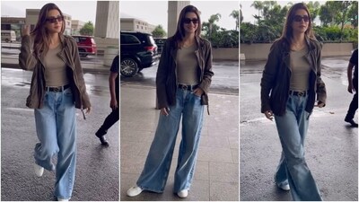 Kriti Sanon's airport look is a 101 fashion class on how to look chic without giving up on your comfort. The actor wore an olive green fitted top, flared acid-washed denim jeans, and a bomber jacket. She styled the ensemble with rectangles-shaped sunglasses, sneakers, loose tresses, a leather belt, and minimal glam. (HT Photo/Varinder Chawla) Kriti Sanon's airport look is a 101 fashion class on how to look chic without giving up on your comfort. The actor wore an olive green fitted top, flared acid-washed denim jeans, and a bomber jacket. She styled the ensemble with rectangles-shaped sunglasses, sneakers, loose tresses, a leather belt, and minimal glam. (HT Photo/Varinder Chawla)