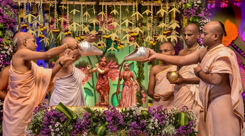 Devotees perform 'abhishek' of Lord Krishna as part of Janmashtami celebrations. (PTI Photo) Devotees perform 'abhishek' of Lord Krishna as part of Janmashtami celebrations. (PTI Photo)