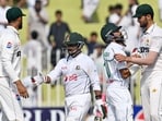 Bangladesh's Shadman Islam (2R) and Zakir Hasan (2L) greet Pakistan's players after their team's win at the end of the fifth and final day of the first Test cricket match. Bangladesh's Shadman Islam (2R) and Zakir Hasan (2L) greet Pakistan's players after their team's win at the end of the fifth and final day of the first Test cricket match.