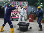 People wearing protective gear use sledgehammers to break a television set to vent their anger outside the Shadow Rage Room in Lagos, Nigeria, Sunday, July 28, 2024. (AP Photo/Sunday Alamba)