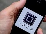 A photo illustration shows the Uber app logo displayed on a mobile telephone.