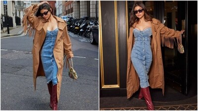 Mouni Roy takes London by storm with her fashion prowess. She stuns in a bodycon denim dress with a buttoned bodice, layered with a brown trench coat. Ruby red thigh-high boots, black sunglasses, and a chic bag completed her stunning look. (Instagram/@imouniroy) Mouni Roy takes London by storm with her fashion prowess. She stuns in a bodycon denim dress with a buttoned bodice, layered with a brown trench coat. Ruby red thigh-high boots, black sunglasses, and a chic bag completed her stunning look. (Instagram/@imouniroy)