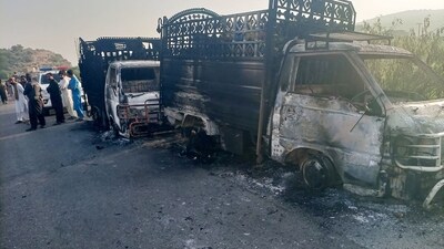 Security personnel stand near the charred vehicles at the shooting site on the national highway in Musakhail district, Balochistan province (Photo by AFP) (AFP) Security personnel stand near the charred vehicles at the shooting site on the national highway in Musakhail district, Balochistan province (Photo by AFP) (AFP)