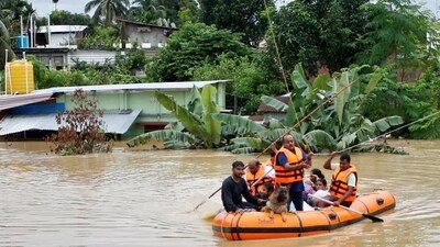 Rescuers from Tripura Disaster Management Authority evacuate flood-affected people to a safer place (Reuters Photo)