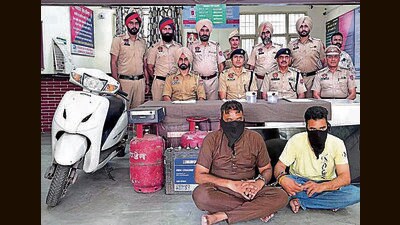 The accused in custody of police along with the recovered items in Ludhiana on Monday. (HT Photo)